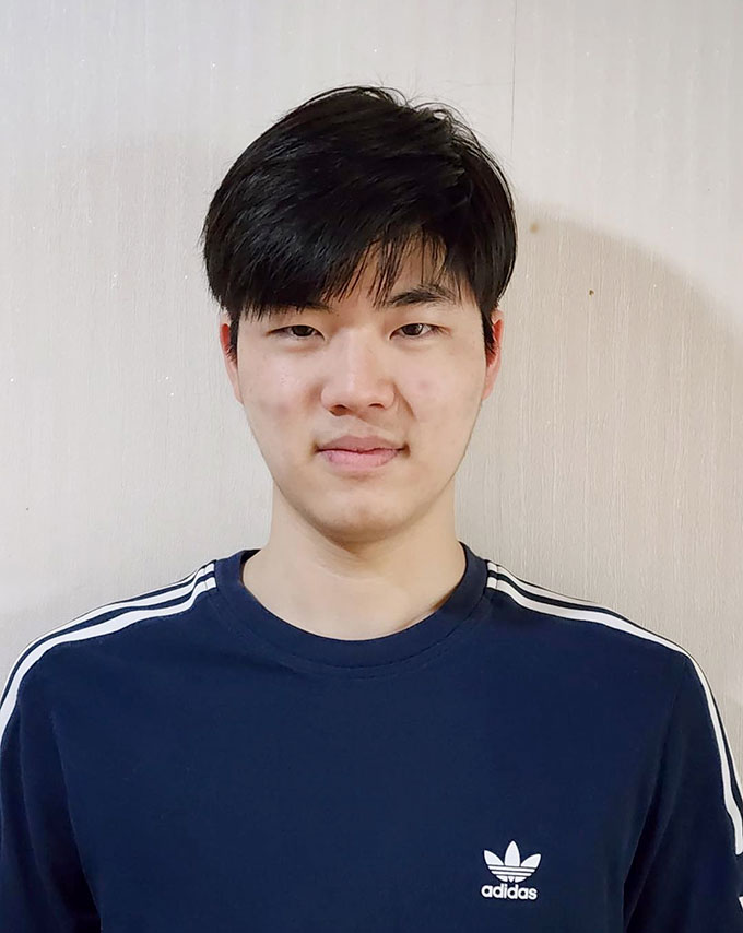 a photo of Jeesung Lee, a young Asian man with black hair smiling at the camera. He's wearing a long-sleeved navy blue Adidas shirt.