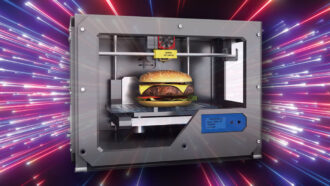 a microwave-type machine has a cheeseburger inside it; the background is a purple and red starburst