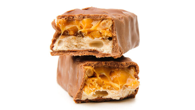 a candy bar split in half vertically and stacked on top of itself. It's a chocolate bare with a nougat and caramel filling