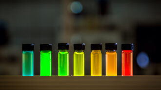 Liquids in 7 vials glow different colors thanks to infusions of quantum dots of different sizes.