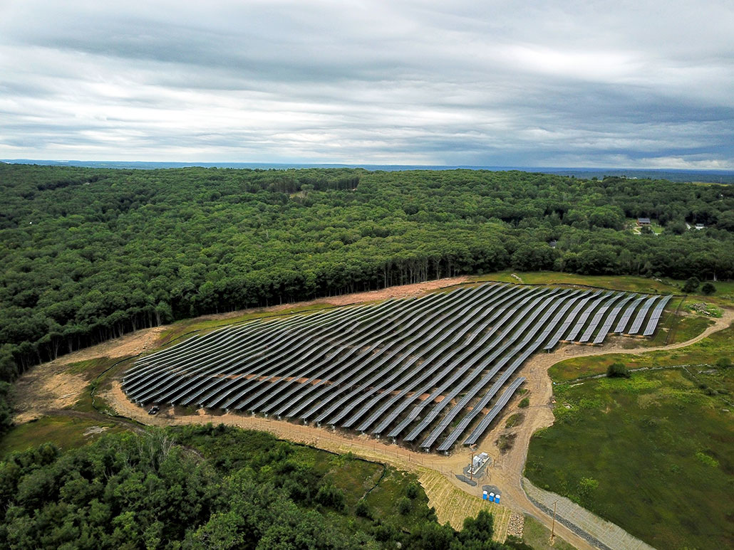 an aerial view of a farm with many solar panels