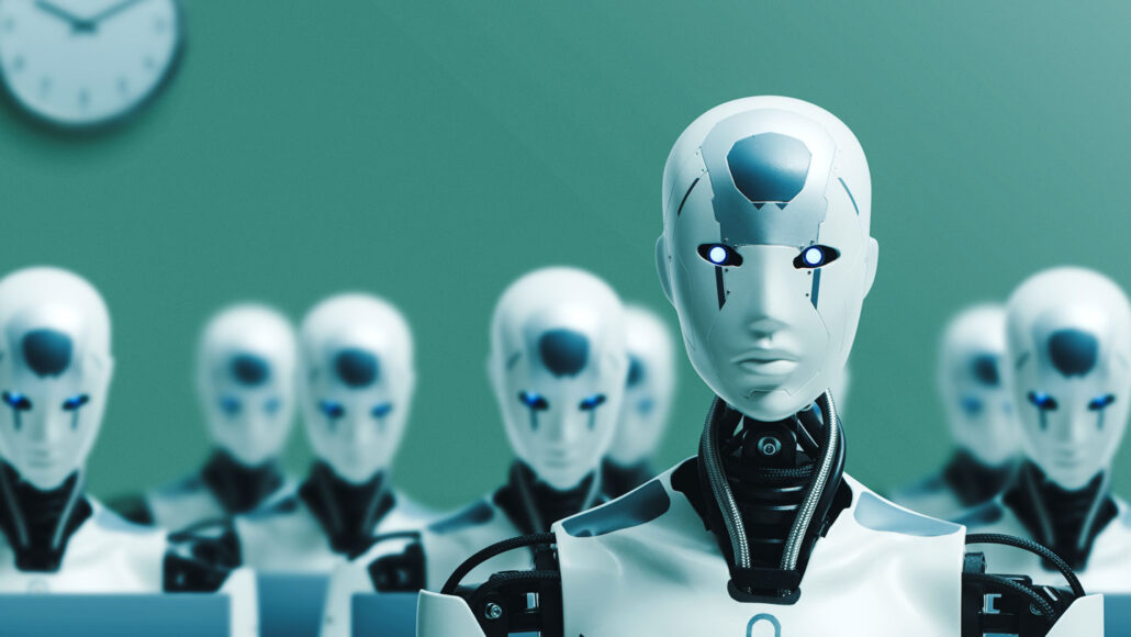 Eight white androids with black necks and shoulder joints stand in a teal colored room. The frontmost android is looking up. A clock hangs on the wall to the left.