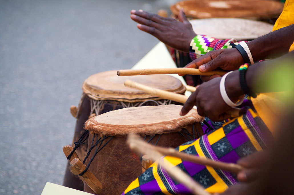 a photo of drummers drumming on African drums