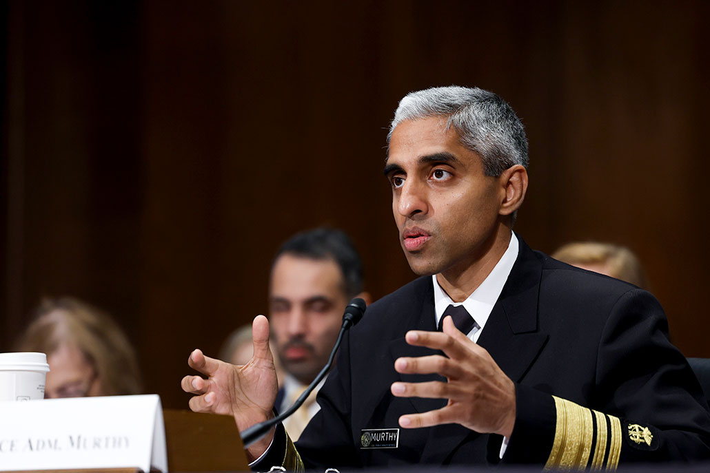 a photo of Surgeon General Vivek Murphy in uniform and testifying before the US Sentate