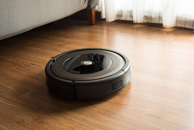 a robot vaccum on a wood floor