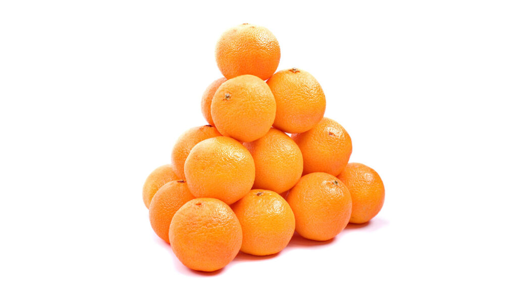 a bunch of oranges stacked in a pyramid against a white background