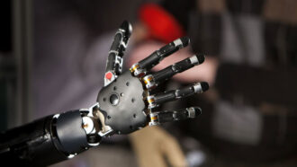 a silver robotic hand with its finger open