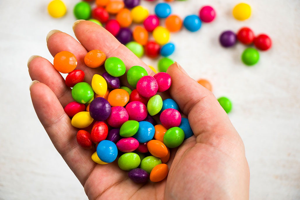 a handful of brightly colored round candies resembling skittles