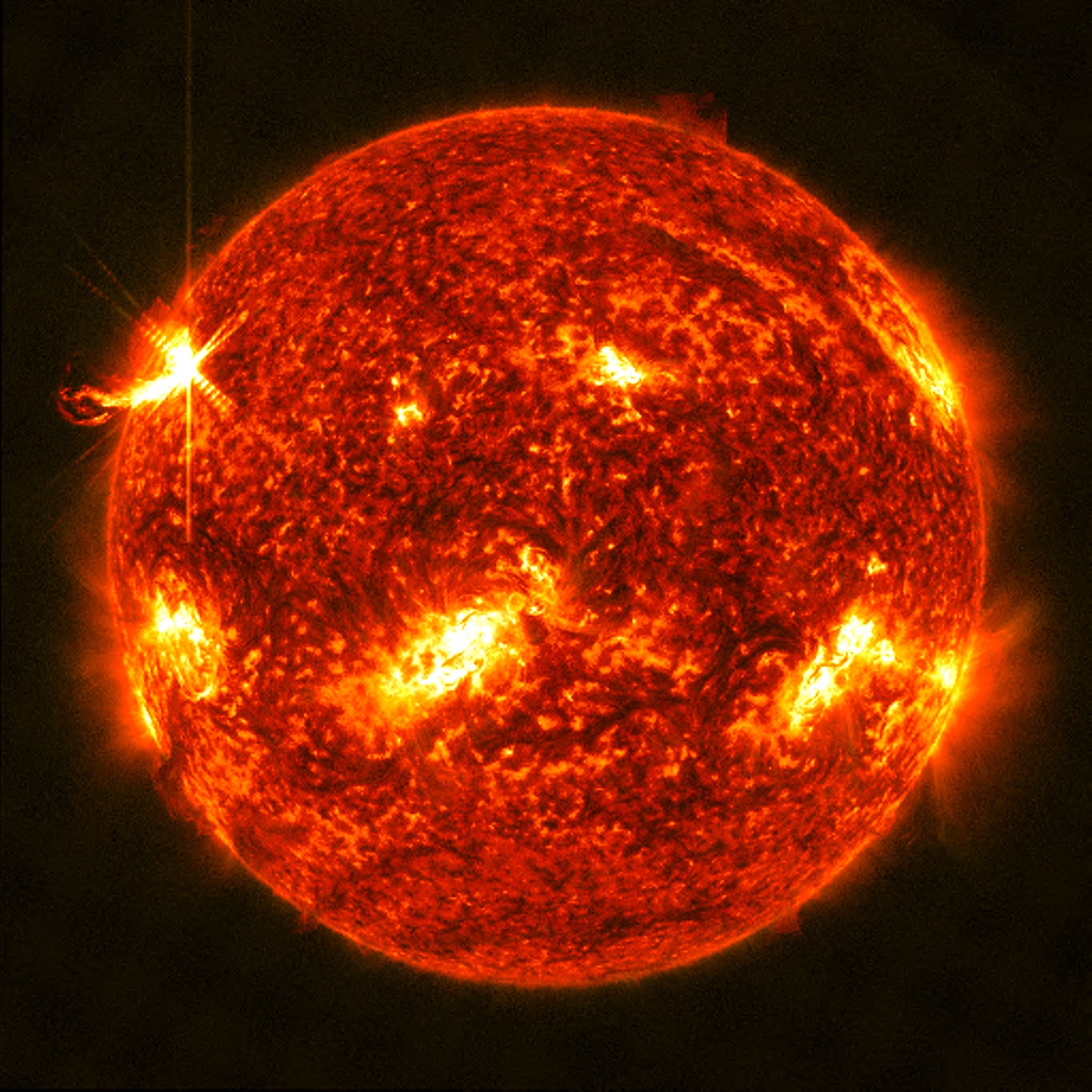 a reddish image of the sun is mottled with bright yellowish-white regions