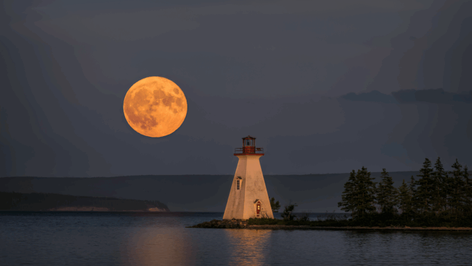 A supermoon rises over a lighthouse on Kidston Island off the coast of Nova Scotia, Canada