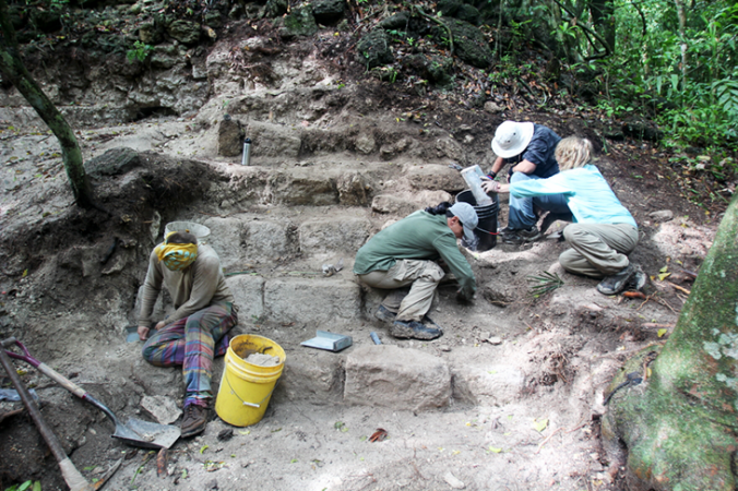 a photo of archaeologists and volunteers working to excavate an archaelogical site