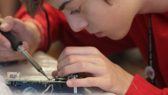 Rafael Brustolin of Bom Principio, Brazil, patiently solders electronic components onto a circuit board. He and 23 other delegates from around the world spent part of their time at the Broadcom MASTERS International program building their own working radi