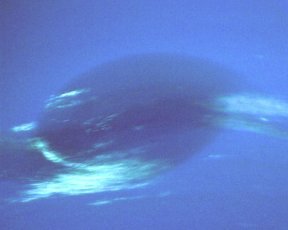 A closeup on a dark storm spot on a blue planet