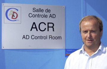 Rolf Landua stands at the entrance to the Antiproton Decelerator (AD) control room.