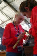 Samantha Bates and Elizabeth Monier hammer on copper to make sure that the wing has the correct shape.