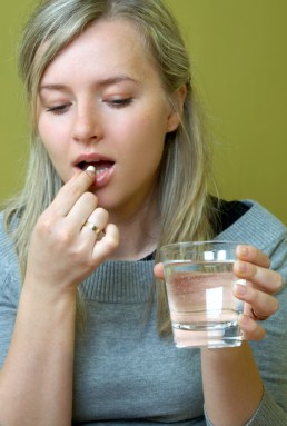 woman taking medicine