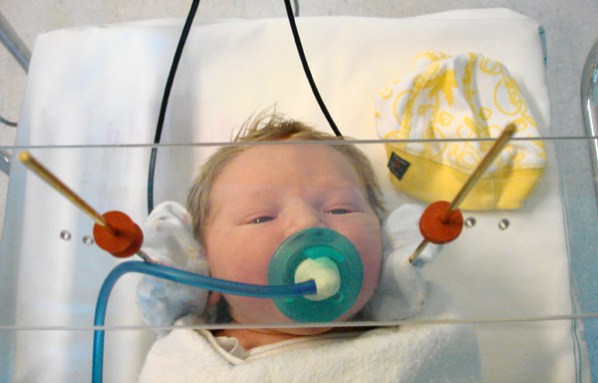 A special pacifier helped researchers study how newborns respond to different vowel sounds. Scientists propose that babies start to recognize language before birth. Credit: C. Moon