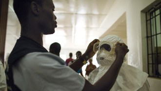 health care workers putting on protective gear