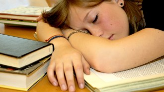 girl sleeping on books