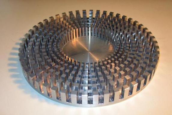 A model of a tsunami cloak. This model is just 10 centimeters (less than 4 inches) across. Larger shields could surround vulnerable locations along coastlines and protect them from tsunamis. Credit: M. Farhat/S. Enoch/S. Guenneau/A.B. Movchan