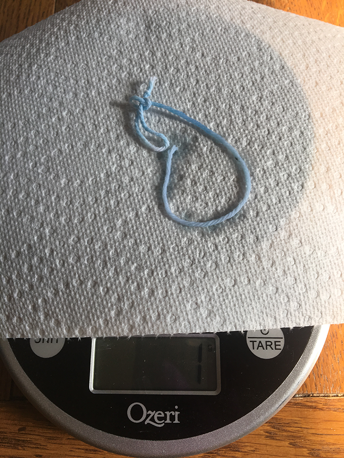 a wet blue string on a scale