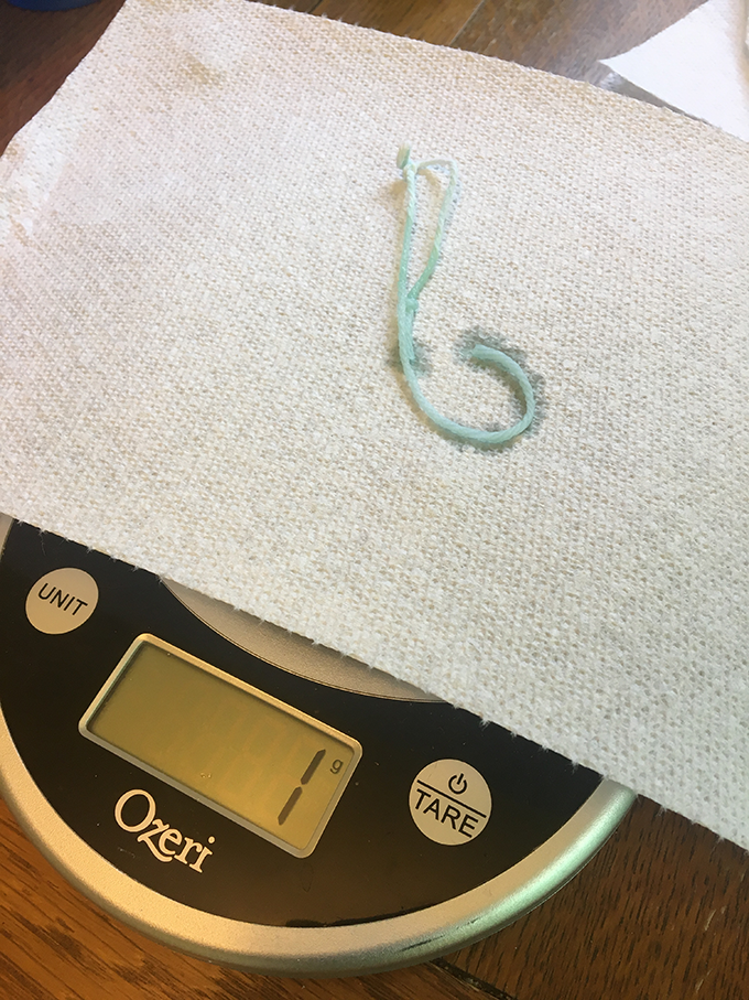 a wet green string on a scale