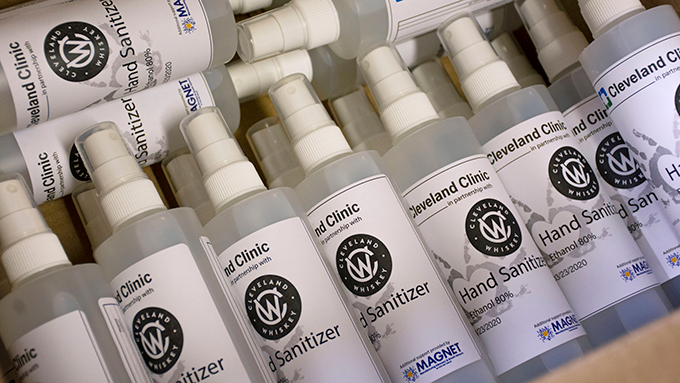 a stack of hand sanitizer spray bottles