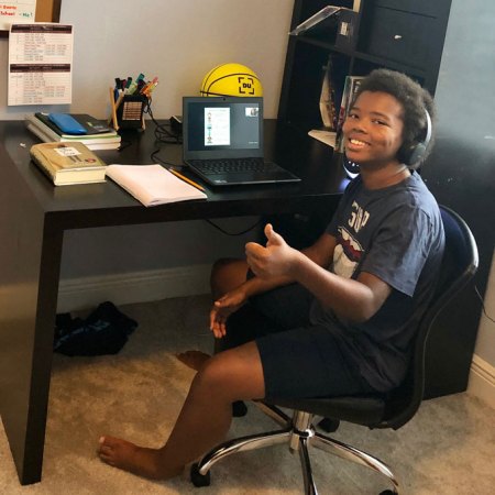 a photo of Tyson Terry at his desk attending virtual class