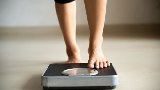 a photo of feet stepping onto a scale