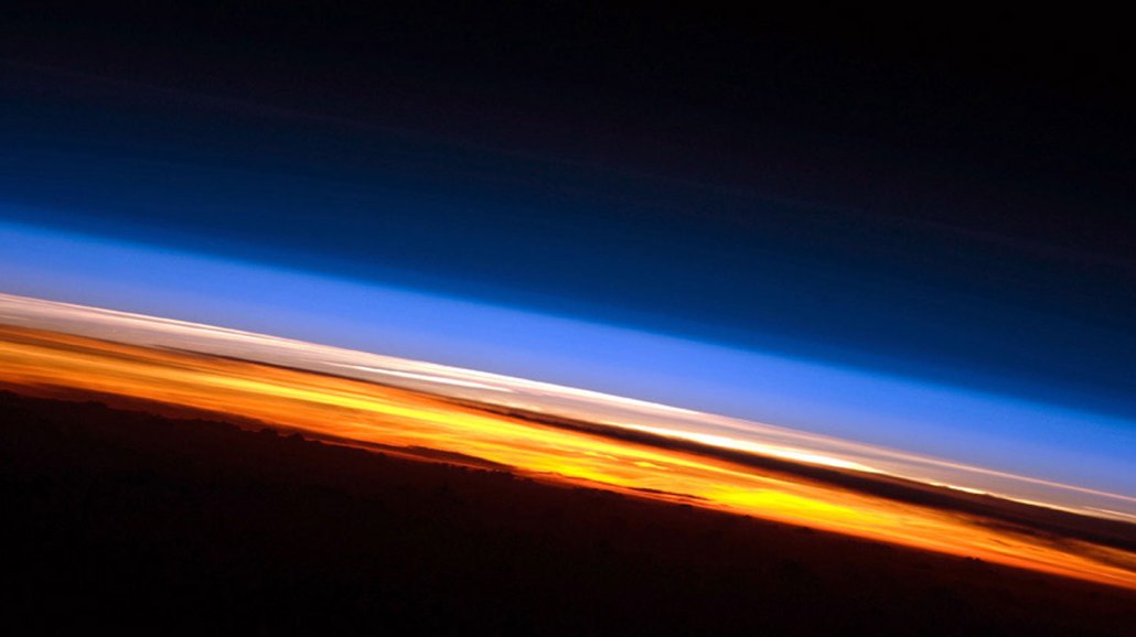image of Earth's atmosphere with the troposphere visible in orange