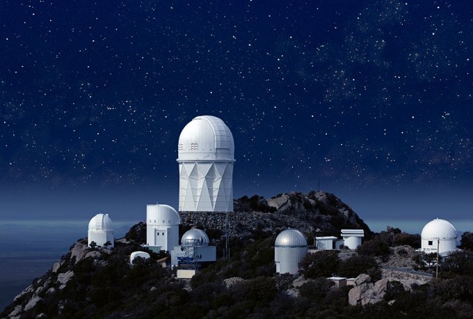 a photo of the Kitt Peak National Observatory at night