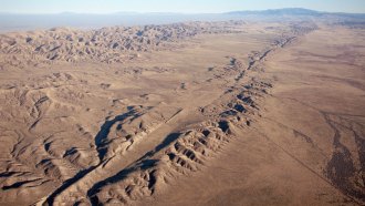 the San Andreas fault appears as a ridge across flat, brown terrain