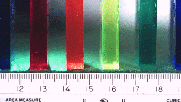 an animated image showing how dominoes stood on end on a felt surface fall