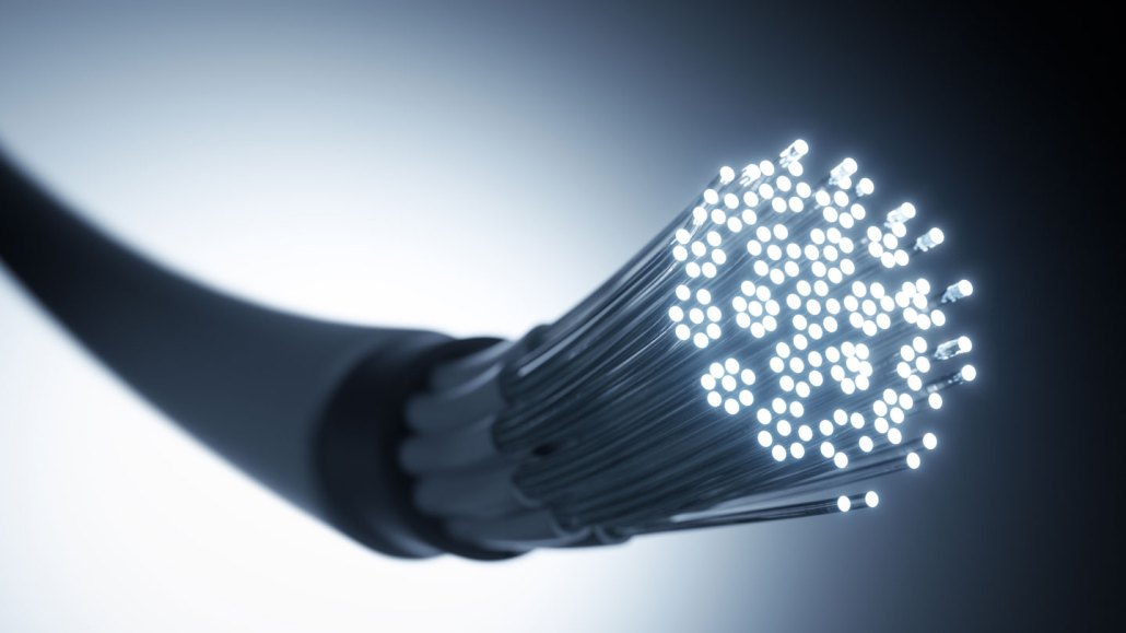 an illustration shows a cable with a smooth outer coating, which has a bundle of thin, light-carrying fibers inside and sticking out of the end