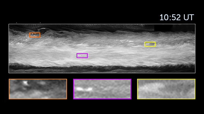 A close up of an area from the previous false-color image of Jupiter. The image is seen in black and white with three bright features outlined in colored boxes seen 10:52 UT.