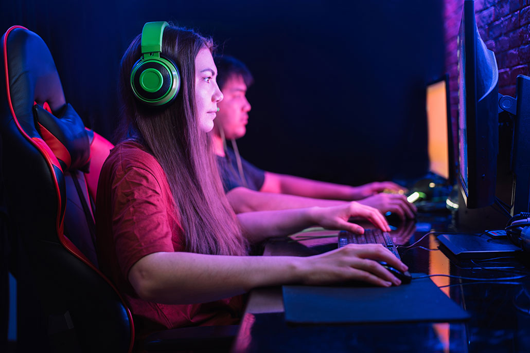 a girl and a guy both concentrating on playing a video game