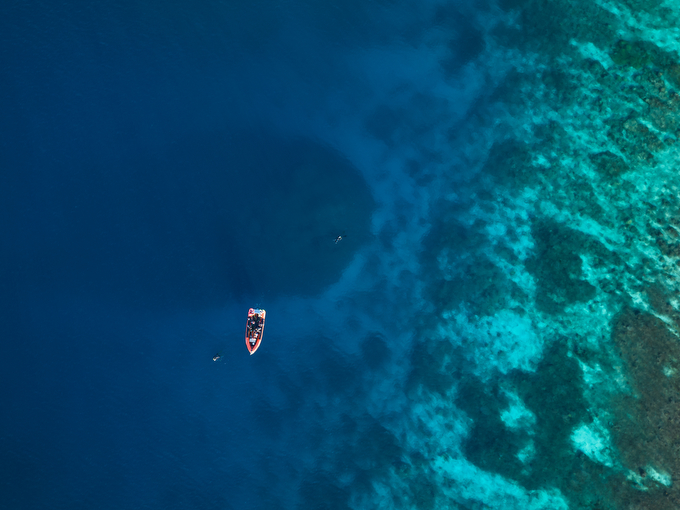 an aerial view of a boat at sea