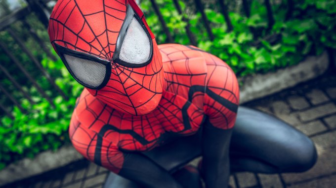 A close-up of Spider-Man crouched on a building