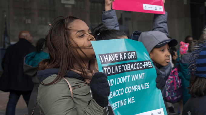 A crowd of young people holding signs, including one saying "I have a right to live tobacco free"