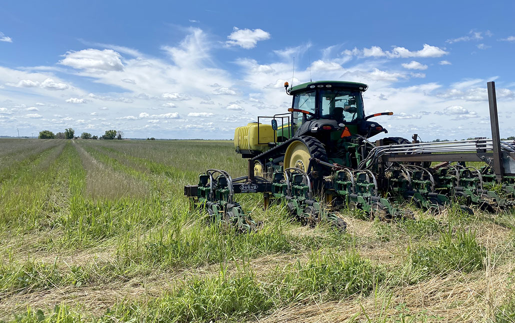 a tractor using a no-till drill to plant seeds