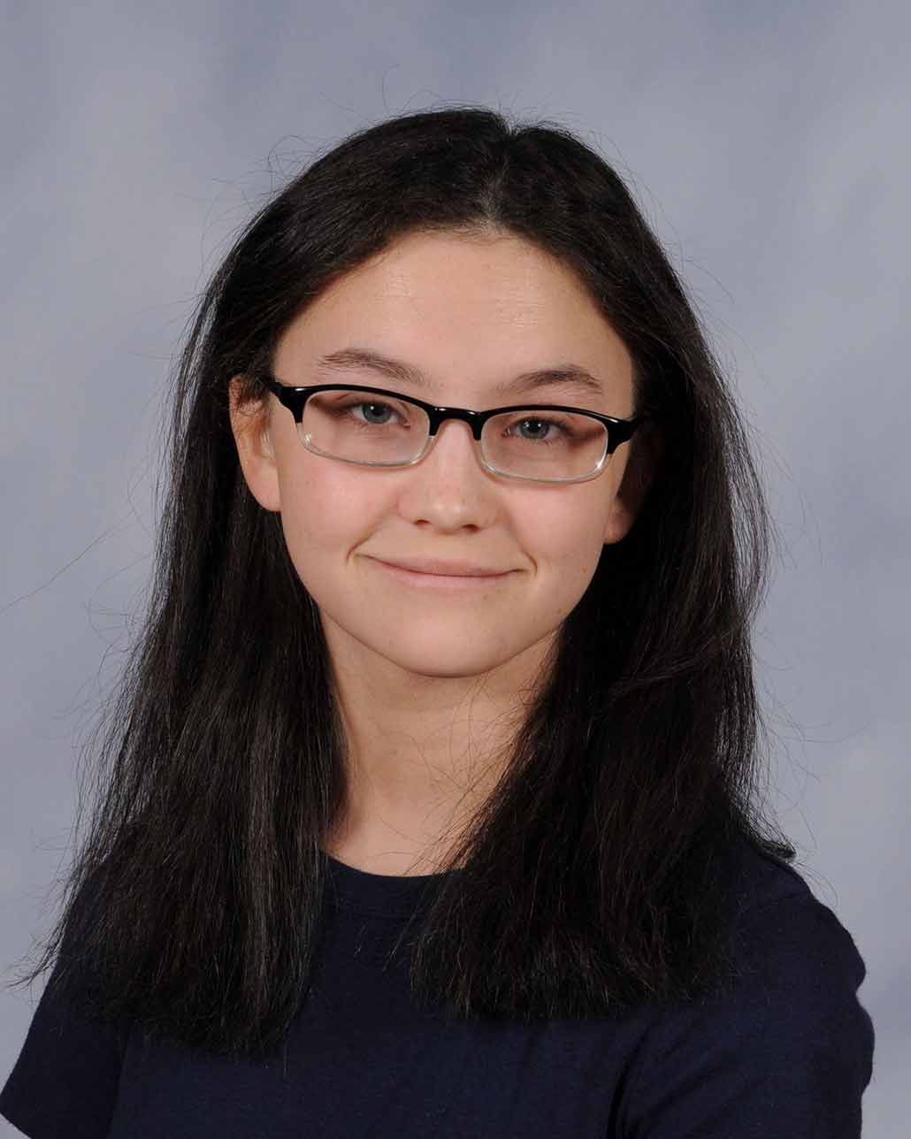 a picture of Emma Tillery, a young woman with glasses, light skin and dark hair