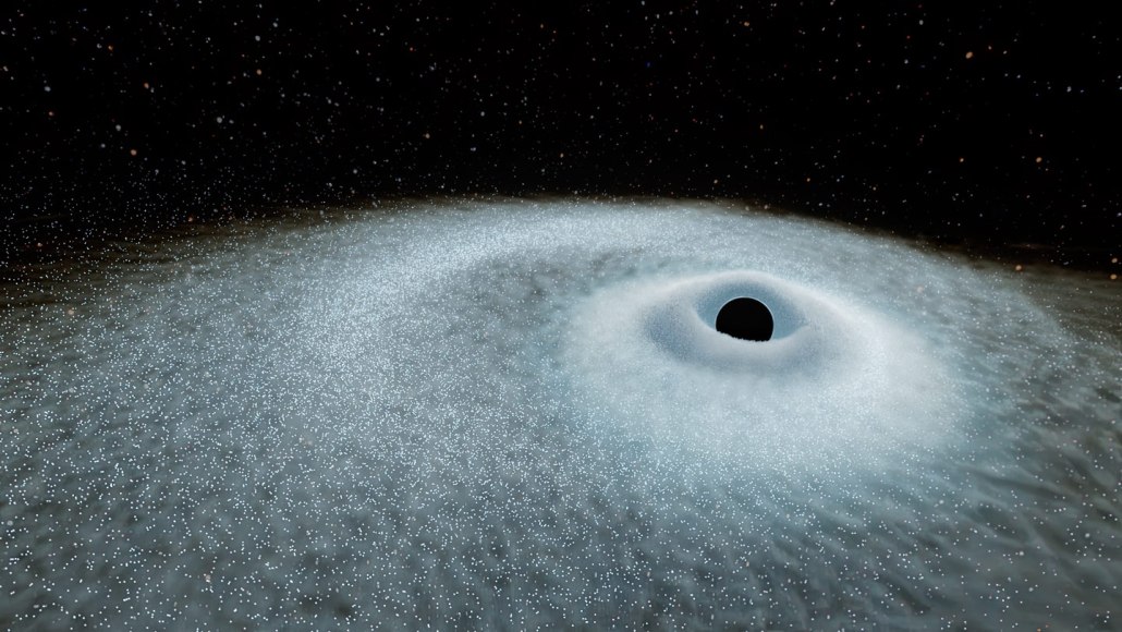 Illustration of a spherical black hole surrounded by a disk of glittering remnants of a star.