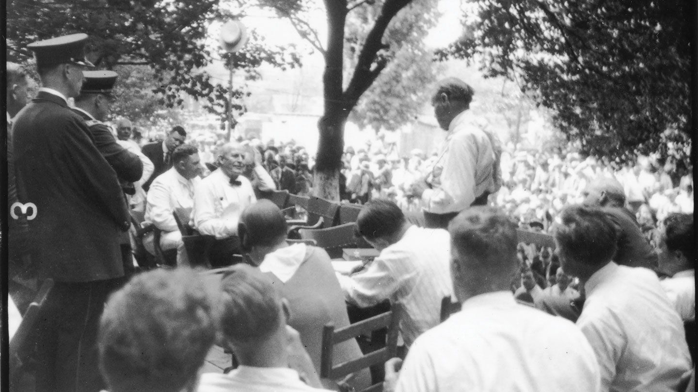 Two people having a discussion among a crowd of people watching.