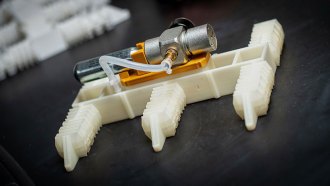 a robot with six squishy arms sits flat on a table