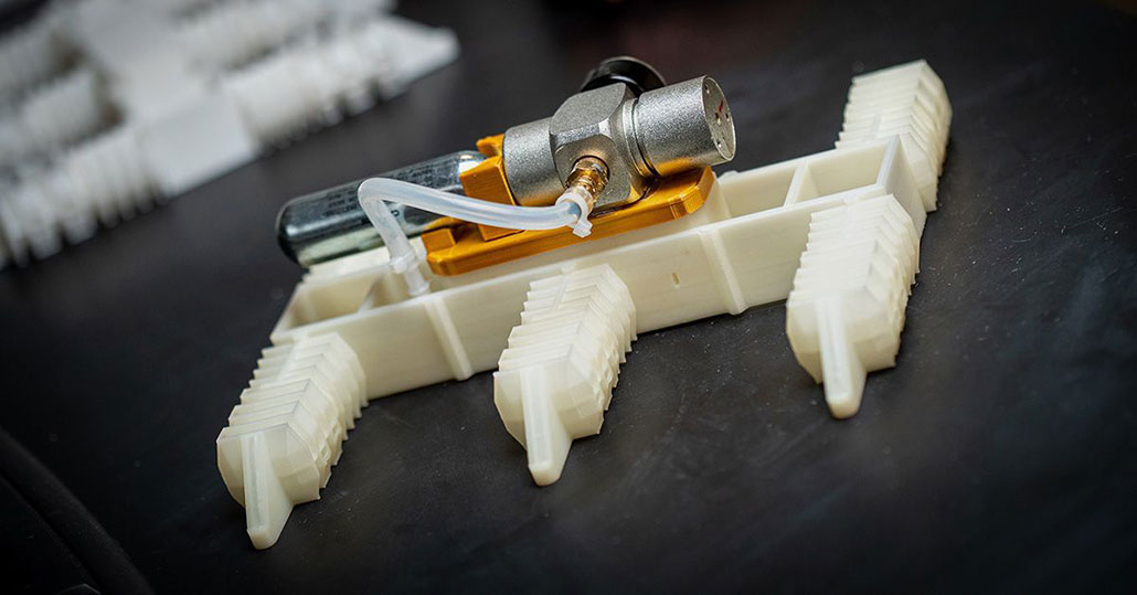 a robot with six squishy arms sits flat on a table