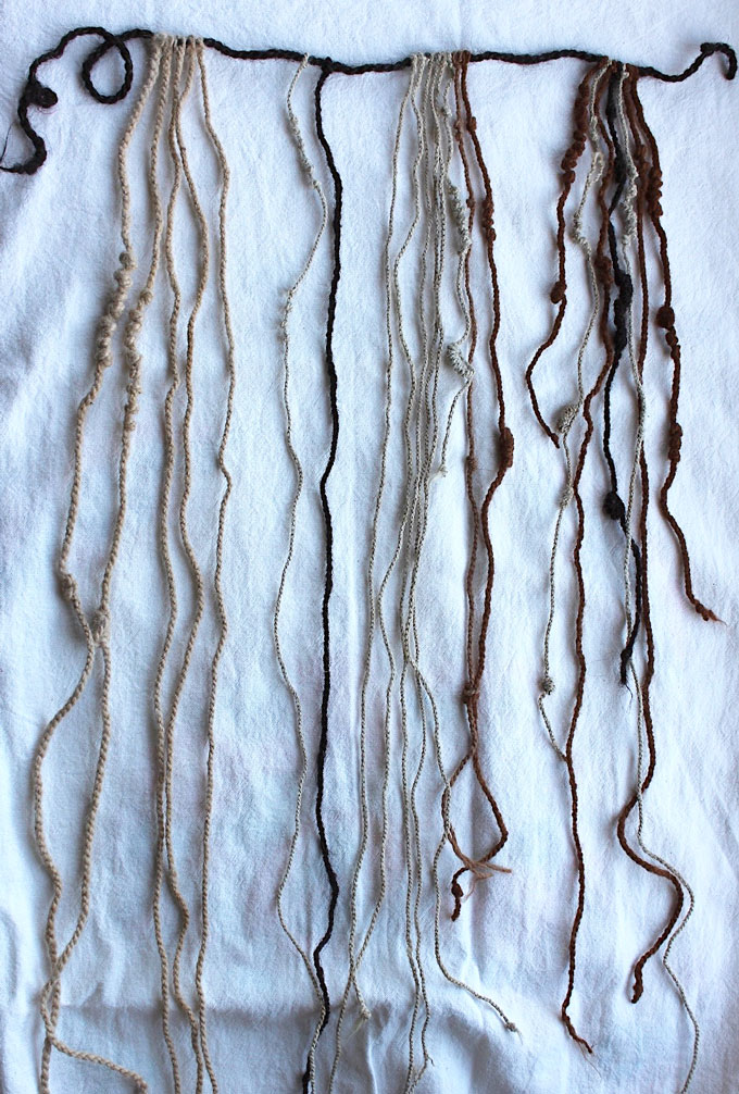 This image shows a khipu, an Inca recordkeeping device. It consists of a string across the top from which knotted strings dangle. The strings are made of human hair.
