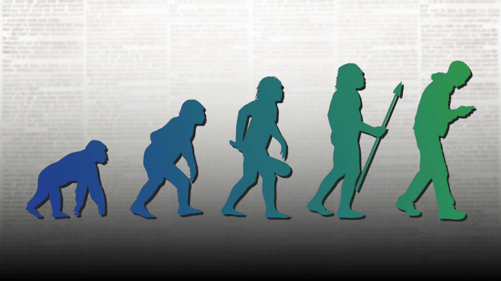 silhouttes of ancient ancestors of humans from left (most ape like) to right (modern human with smart phone) over a newspaper