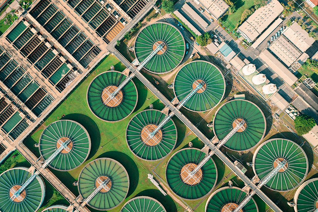 an aerial view of circular vats of water at a water treatment plant, which normally treat pee as waste