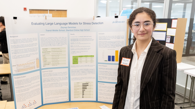 Zeynep Demirbas stands in front of her poster on using AI models for stress detection.
