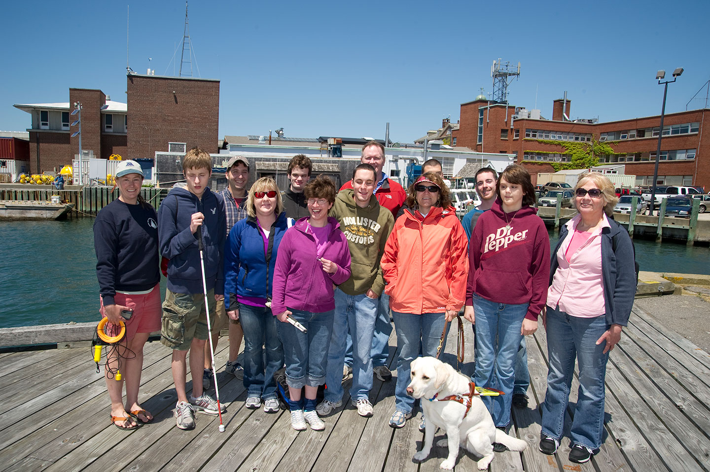 Amy Bower and a group dof students take a photo on a pier.